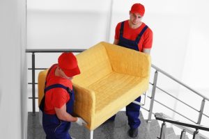 two-male-workers-with-yellow-couch-staircases